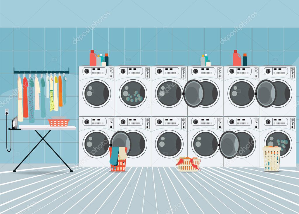 A row of industrial washing machines in laundry shop.