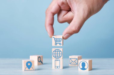 Wood block cubic stacking up with Cart Email World Wide Web Smart Phone User login Location icon. Blue Tone. Business growth success process. Business Concept. Shopping online.
