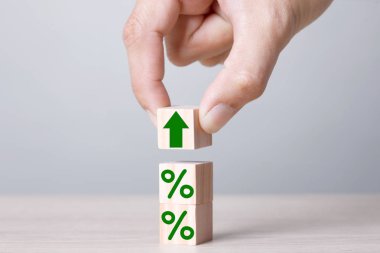 Wood block cubic stacking up with green arrow up and Percent warm Tone. Business growth success process. Business Concept.