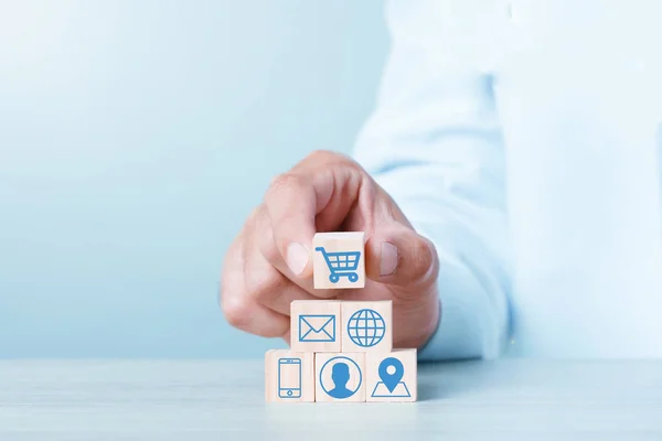 Wood block cubic stacking up with Cart Email World Wide Web Smart Phone User login Location icon. Blue Tone. Business growth success process. Business Concept. Shopping online.