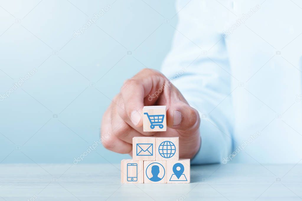 Wood block cubic stacking up with Cart Email World Wide Web Smart Phone User login Location icon. Blue Tone. Business growth success process. Business Concept. Shopping online.