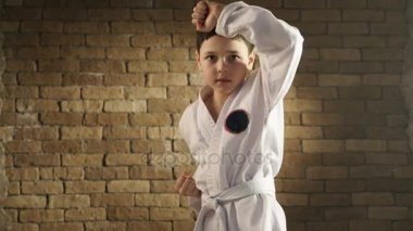 Bir geleneksel kimono içinde küçük bir karateka karmaşık kendini savunma hareket etmez