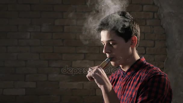 Young boy makes ten smoke rings,and sends one ring inside of another one, in slo- mo — Stock Video