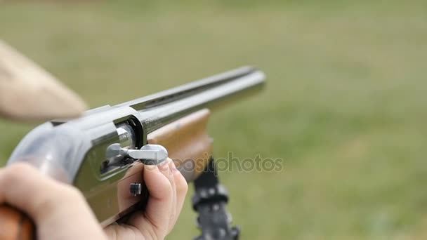 Some man aiming and shooting from a hunting rifle in a field in slow motion — Stock Video