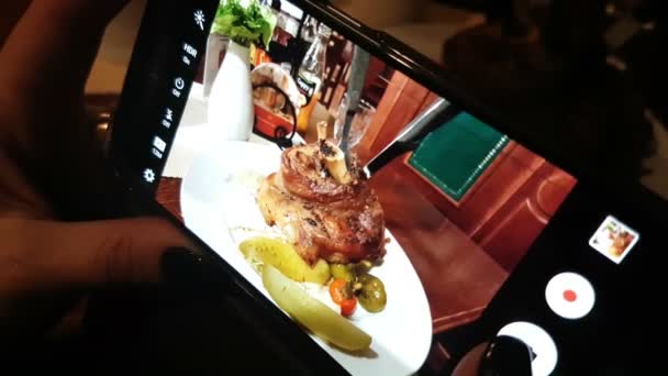 Ένα άτομο φωτογραφίες τηγανητό κρέας με ένα smartphone — Αρχείο Βίντεο