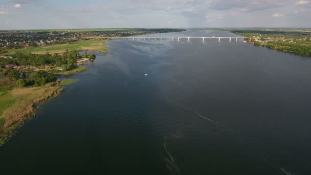 Aerial shot of a car bridge on the Dnipro river, which looks modern and smart — Stock Video