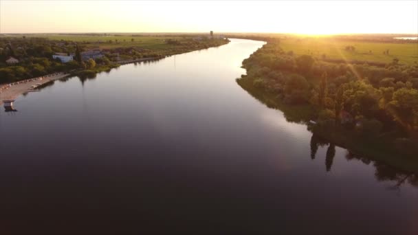 Aerial shot of the Dnipro quaya with an asphalted road and greenary at sunset — Stock Video