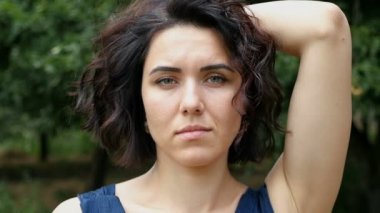 Genç kadın dalgalı saçları romantik tutar ve yaz slo-mo gülümsüyor