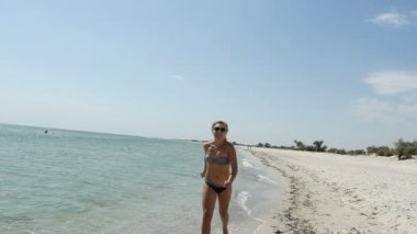 Sportif kadın siyah Bikini yaz slo-mo kumlu kıyı boyunca jogs