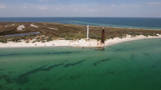 Bird's eye extra lang shot van een vuurtoren en een toren van de grens op de kust van de Dzharylhach — Stockvideo