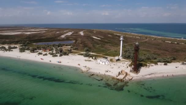 Luftaufnahme eines Leuchtturms und eines Grenzturms an der Küste der Insel Dscharylhach — Stockvideo