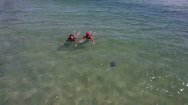 A girl and a woman swim in the Black Sea waters not far from a border tower — Stock Video