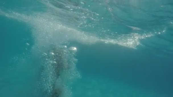 一个令人兴奋的看法 一个快乐的女人跳脚首先在地中海的蓝色水域在黄昏与棕榈的背景 — 图库视频影像