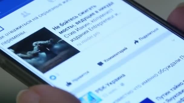 屋内でのプロファイルは スマート フォンの画面で世界のニュースの動画男性手のニコラエフ ウクライナ 2017 クローズ アップ ショット — ストック動画