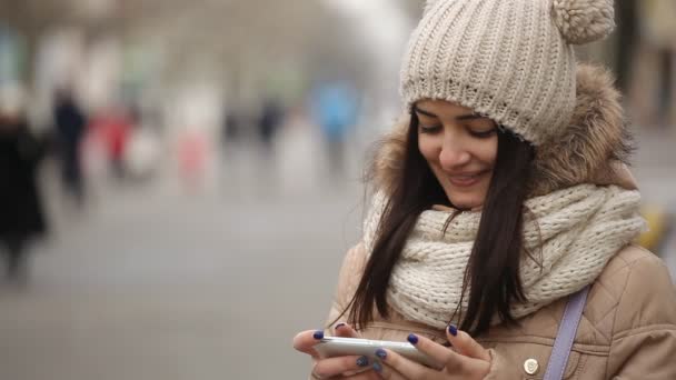 Menina Alegre Sorri Toca Tela Seu Telefone Inteligente Beco Inverno — Vídeo de Stock