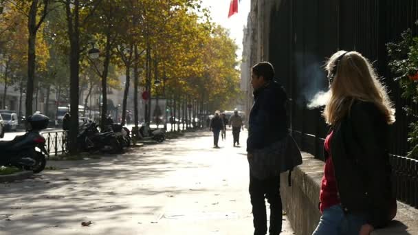 2017年11月3日 一个美丽的金发女人 她长松散的头发上戴着耳机坐着 在一个街道上的 Papapet 在秋天在巴黎的慢动作吸烟 — 图库视频影像