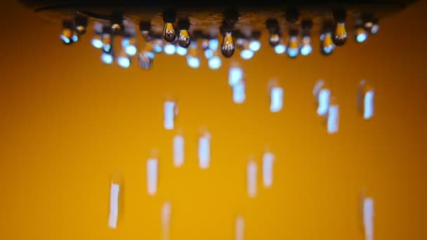 Flashing Droplets Fall Slowly Shower Nozzle Brown Bathtub Art Macro — Stockvideo