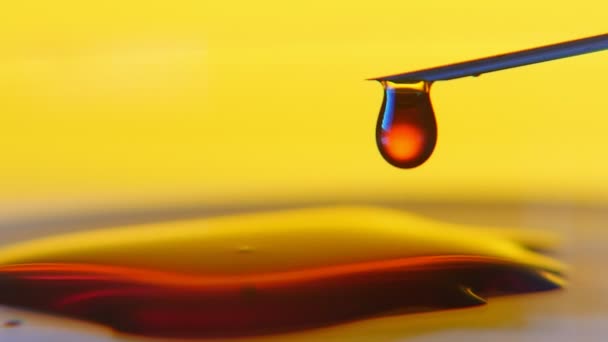 Metalik Bir Iğneden Sarı Arka Planlı Küçük Sıvı Çamura Düşüyor — Stok video