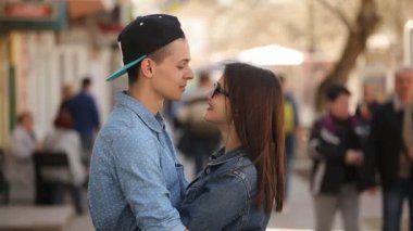 Genç çift birbirinize sarılın, öpücük ve güzel bir sokak baharda güzel bir genç kadının erkek arkadaşı güzel bir sokakta tutkuyla bahar güneşli bir günde öpüşme romantik bir profil gülümse. Onlar mutlu hissediyorum.