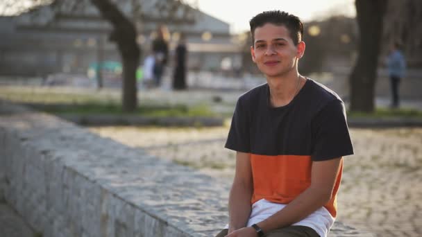 Happy Teenager Sits Dnipro Quay Smiles Cheerfully Sunny Day Bokeh — Stock Video