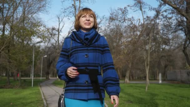 Optimistische Blonde Vrouw Gaat Glimlacht Een Zonnig Park Herfst Slow — Stockvideo