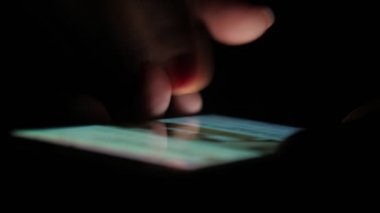 Facebook bilgileriyle akıllı telefon ekranına dokunan ve hareket eden erkek parmakları, Facebook mesajları ve resimleriyle akıllı telefon ekranına dokunup kaydıran bir adamın harika yakın plan görüntüsü. İnternette geziniyor ve bilgi arıyor.