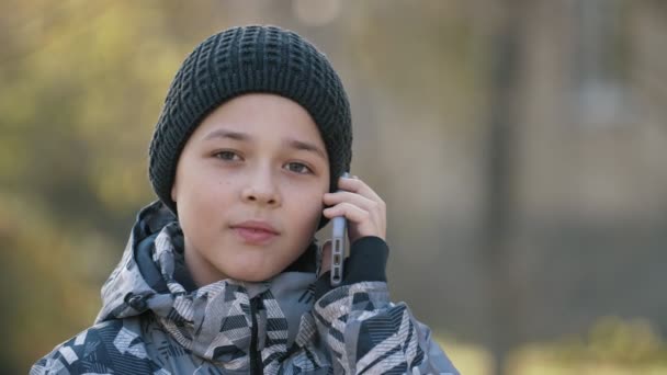 Cheery Child Knitted Hat Talking His Grampa Phone Park Autumn — Stock Video