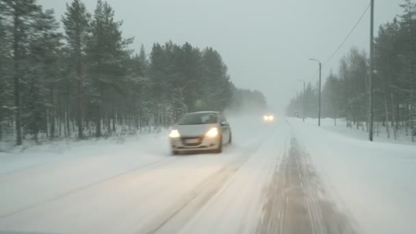 Weiße Straße Mit Einem Schweren Schneesturm Kiefern Und Fahrende Autos — Stockvideo