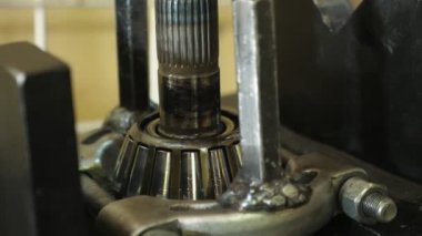 Konik silindirlerle yavaş yavaş hareket eden metal çubuk aniden beklenmedik bir şekilde yakın plan metalik bir çubuğa çarptı. Konik silindirlerle yavaşça yere düştü ve bir atölyede aniden sert bir şekilde yere çakıldı.