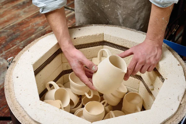 Geroosterde keramische producten zonder glazuur in de potter's handen. — Stockfoto