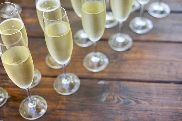 Catering concept, champagne glasses on a wooden boards backgroun — Stock Photo, Image