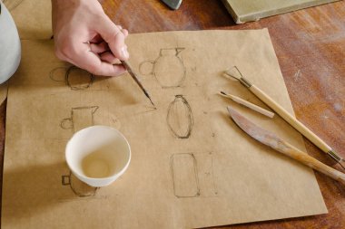 potter seramik ürün kağıt üzerinde çizimler yapar. Conce