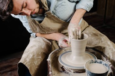 pottery, workshop, ceramics art concept - man working on potter'