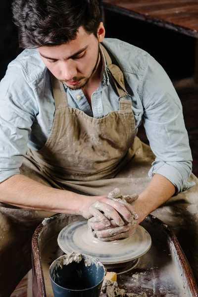 pottery, workshop, ceramics art concept - man working on potter'