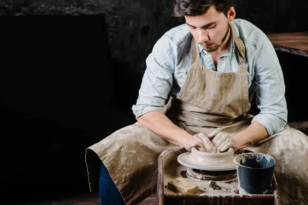 pottery, workshop, ceramics art concept - man working on potter'