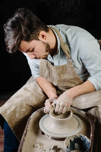 pottery, workshop, ceramics art concept - man working on potter'