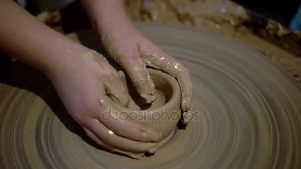 Chica está moldeando en la rueda de cerámica creando un tazón de arcilla, manos de niño sucio — Vídeo de stock