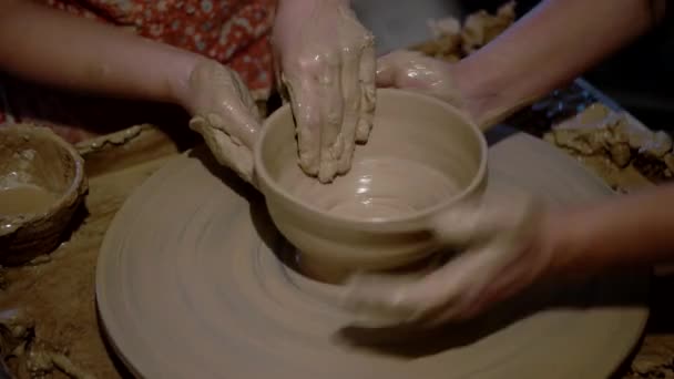 Girl is Molding at Pottery Wheel Creating a Clay Bowl, Dirty Kid 's Hands — стоковое видео