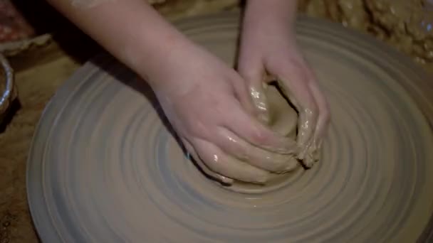 Girl is Molding at Pottery Wheel Creating a Clay Bowl, Dirty Kid 's Hands — стоковое видео