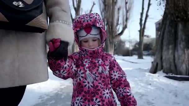 3 χρονών κορίτσι με τα πόδια με τη μητέρα της από ανάχωμα χιονισμένο δρομάκι το χειμώνα. Steadicam Shot — Αρχείο Βίντεο