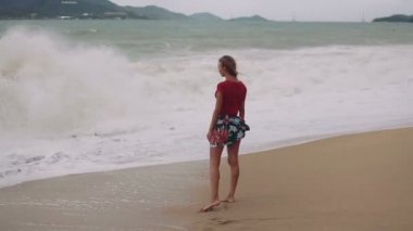 Güzel genç kız ile bir güzel rakam poz ve deniz kıyısı boyunca