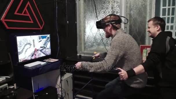 Moskow, Rusia - MARCH 02, 2017: Seorang pria menonton permainan film realitas maya menggunakan layar terpasang kepala Oculus Rift berbasis . — Stok Video