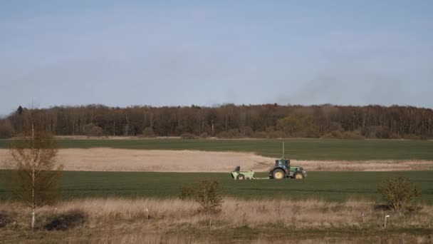 A tractor plows the field and sows simply harvest — Stock Video