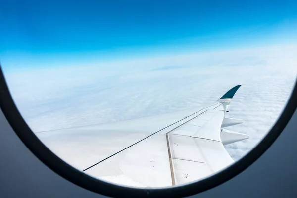 Cloud and blue sky on atmosphere through window of aircraft. — Stock Photo, Image