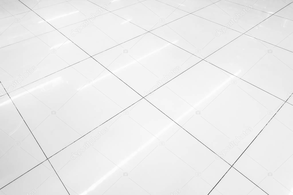 Flooring tile background and reflection of luminaire.