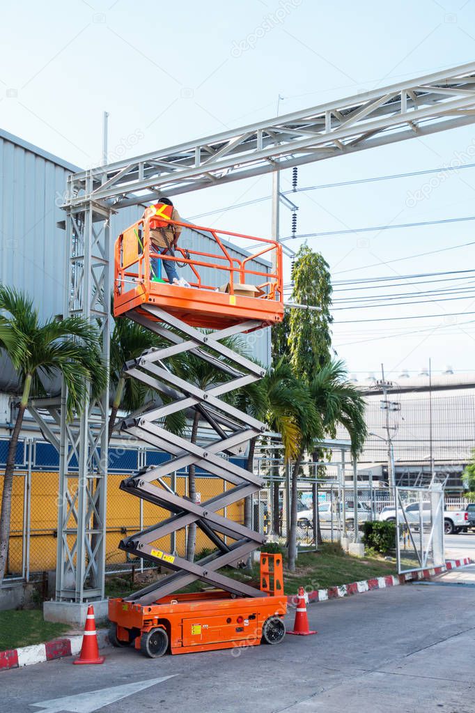 Scissor lift platform and electrical technician operated wiring.