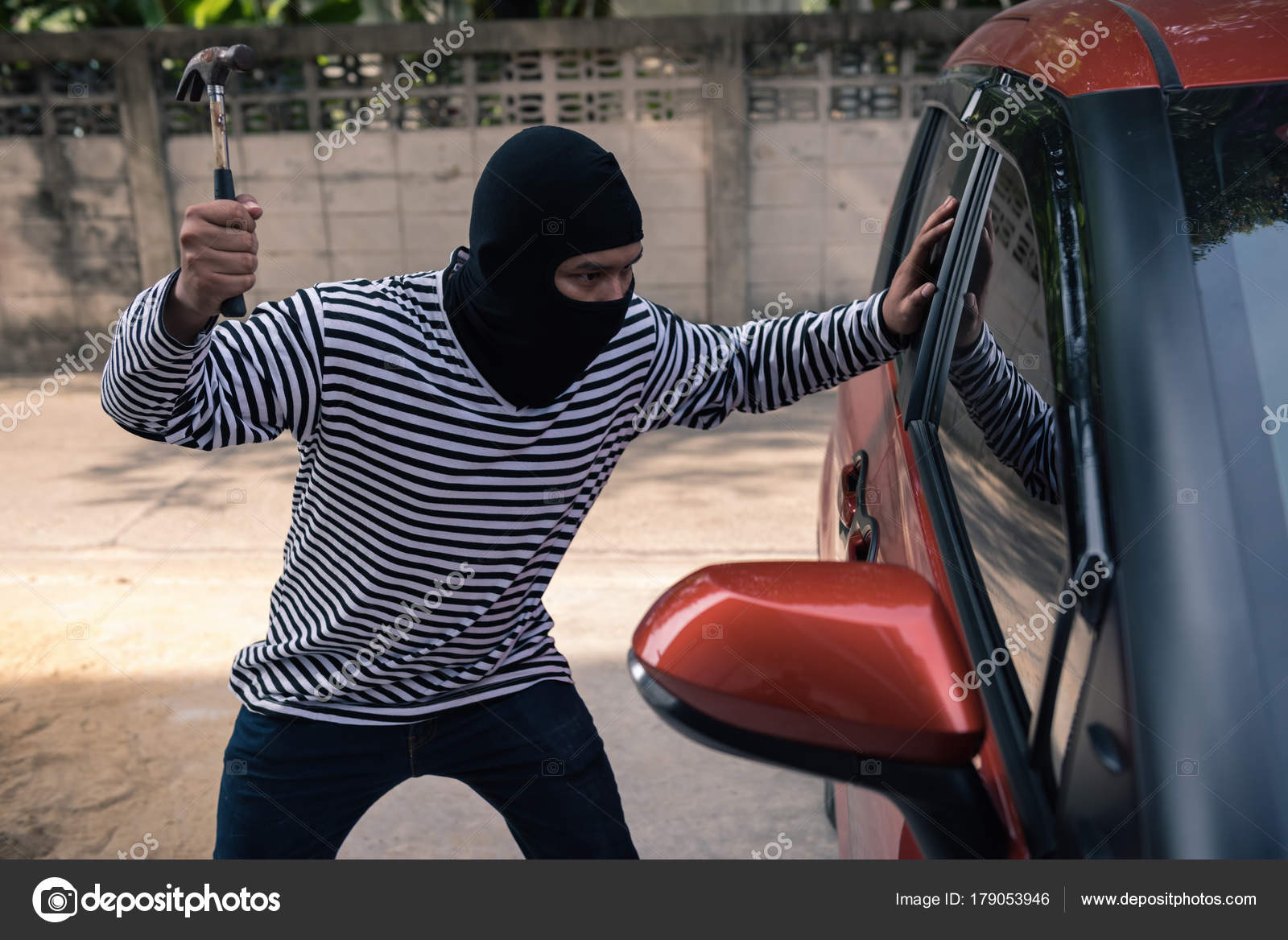 Car Thief Trying To Unlock A Car By Screwdriver Stock