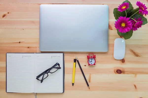 Top view of workspace and computer laptop on table desk