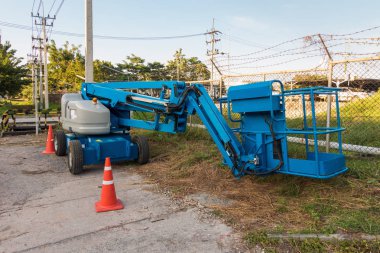 Blue articulated boom lift for construction work 