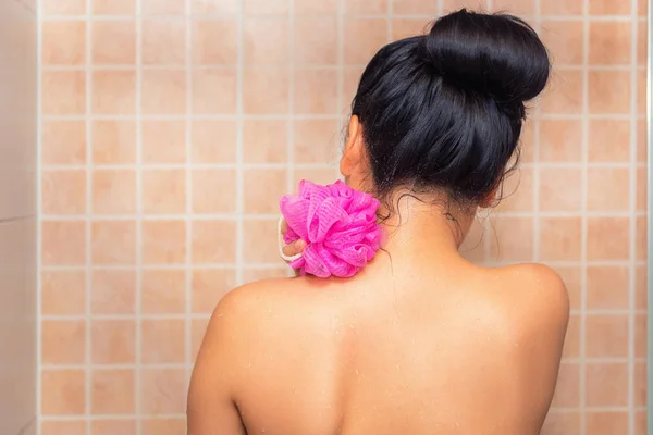 Portrait of beautiful woman taking shower with bath sponge — Stock Photo, Image